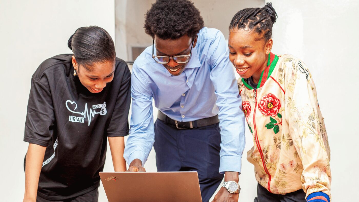 Team brainstorming around a laptop