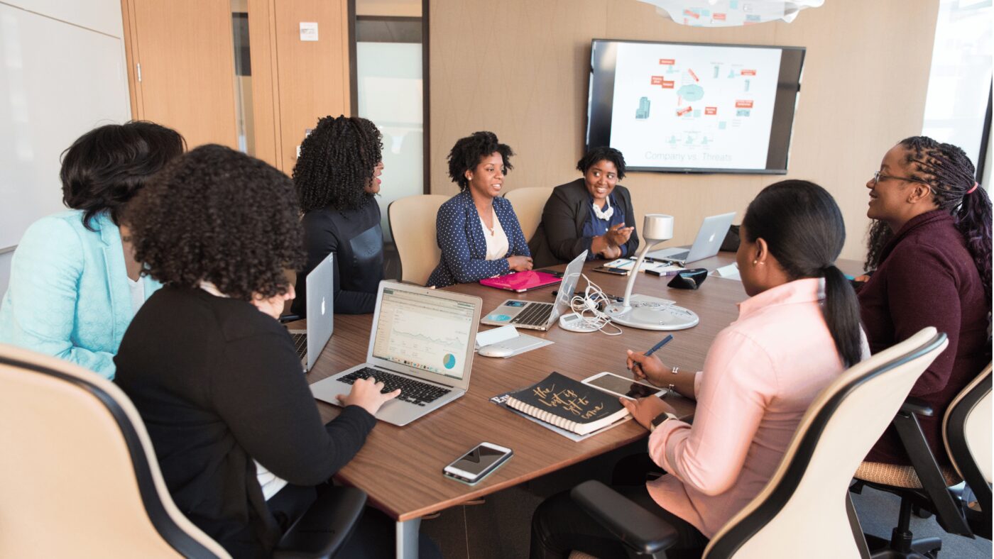 Team collaborating around a whiteboard in a modern office